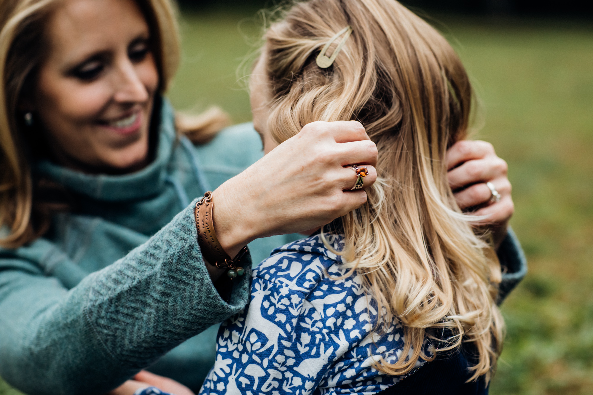 Mom playing with daughters hair
